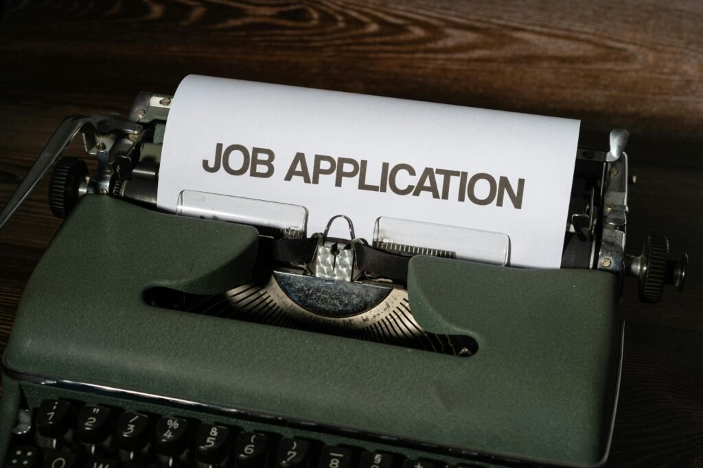 Close-up of a vintage typewriter with a job application paper inserted.